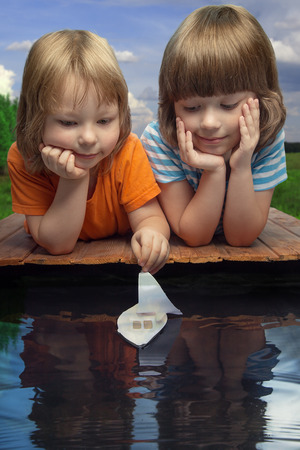 three boy play in puddle summer dayの写真素材