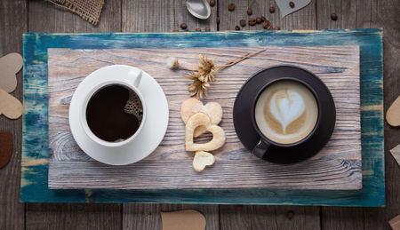 two cup of espresso and cappuccino on the table in a vintage Valentine's Day cookies flowers heartsの写真素材