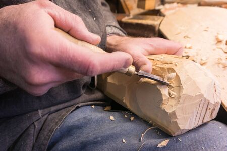 Wood carving close-up of a handの写真素材