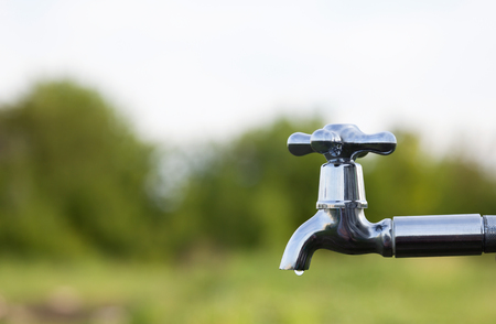 drain water from the tap Metal outdoorsの写真素材