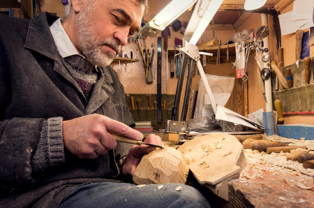 master examines wood carvings, the carpenter checks the finished work.