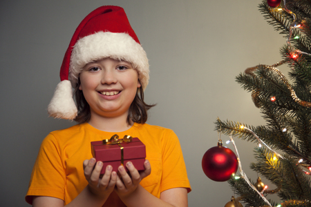 Happy boy with Christmas gift-boxの写真素材