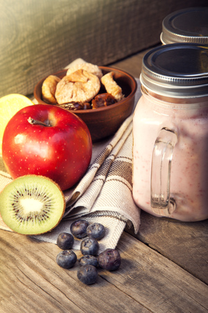Smoothie in glass jar on rustik wood. Healthy beverage and fresh fruit.の写真素材
