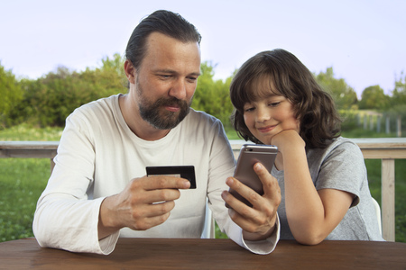 family shopping online in the terrace on a summer eveningの写真素材