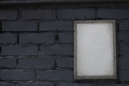 Mock up blank poster picture frame on blue brick wall.の写真素材