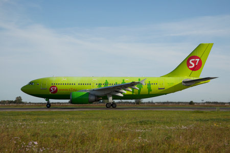 Russia, Tolmachovo, 09 Aug 2009: S7 Airbus A320 is landing at Tolmachevo Airport at sunset - isolated on a blue cloudy sky backgroundのeditorial素材