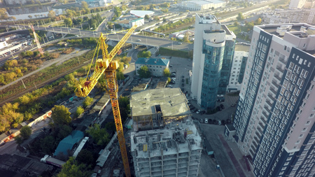 aerial view of the construction site and yellow cranes. new apartment building in progress.
