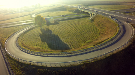 Aerial Top View of highway intersection junction summer morning with car.
