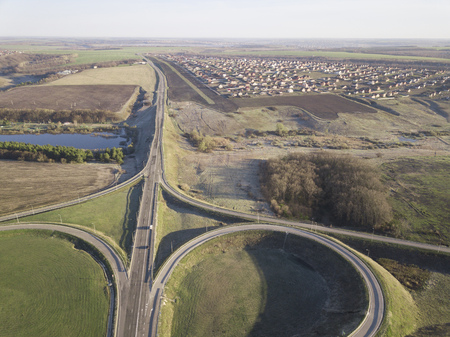 Road Junction highway intersection summer morning with car. Aerial Top View.