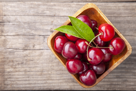 Ripe cherries on wooden table. Top View with copy space.の写真素材