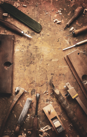 Hand tools Wood (Drill Jig Saw plane chisel) on an old wooden workbenchの写真素材