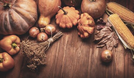 autumn pumpkins and other fruits and vegetables on a wooden thanksgiving table