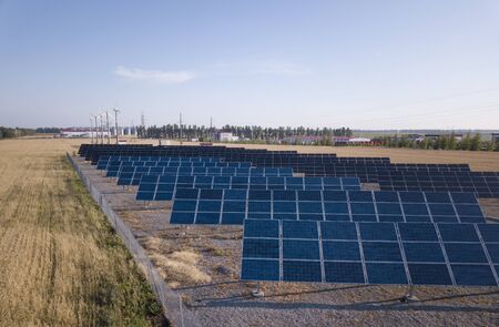 Solar Panel field with snow on panels. Photovoltaic power electrical station.