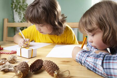 Two Boys write a letter to Santa Claus.の写真素材