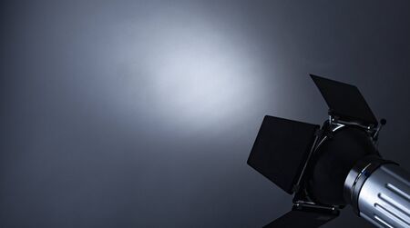 Spotlight shining on grey background