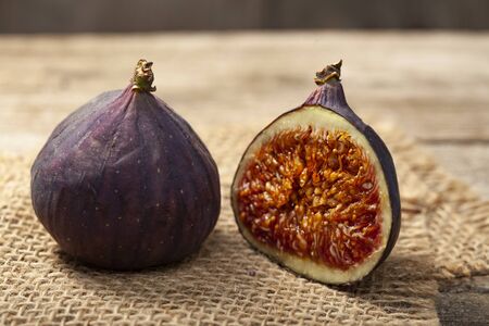 ripe half figs of an old wooden table and burlap.