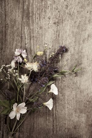 Flowers on old grunge wooden tableの写真素材