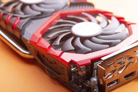 Game graphics video card isolated on orange background.