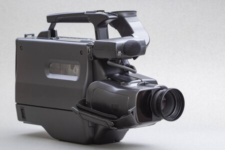 video camera with the microphone isolated on white, in concept of technology, entertainment. Retro...