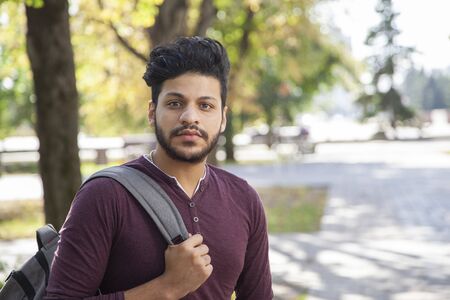 Handsome asian man with backpack in park.の写真素材