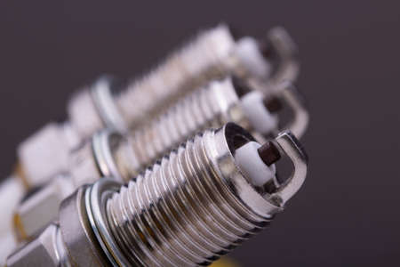 New car spark plugs on gray backgroundの写真素材