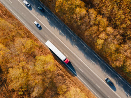 Asphalt highway or motorway road in countryside with car and truck traffic Cargo Semi Trailer...