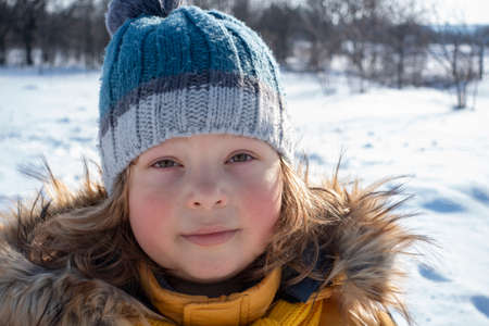 happy boy in snow play and smile sunny day outdoorsの写真素材