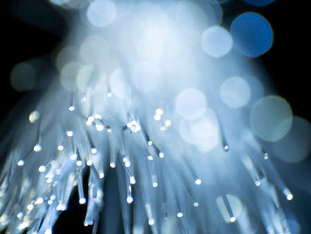 Soft focus Optical fiber network cable on black background, abstract light sparkler