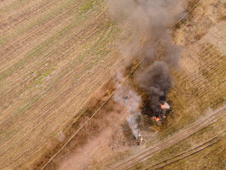 Burning grass on the field in village. Aerial viewの写真素材