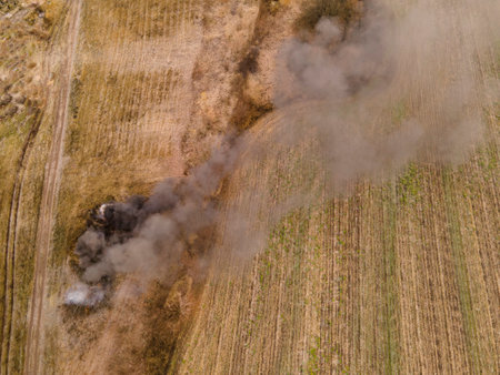 Burning grass on the field in village. Aerial viewの写真素材