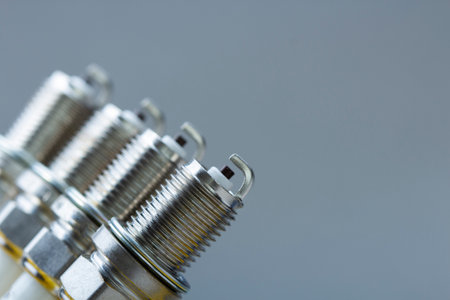 New car spark plugs on gray background