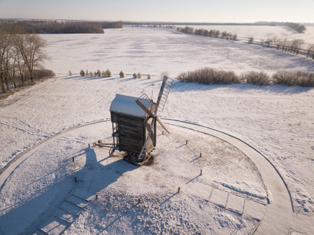 Old wooden windmills aerial top view in the snow winter.
