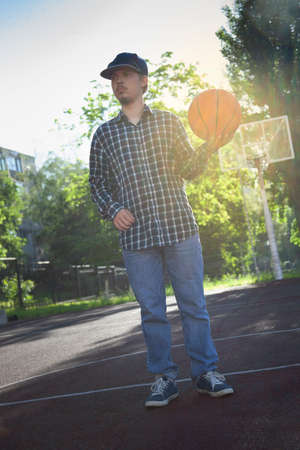 boys playing basketball outdoors on a sports fieldの写真素材