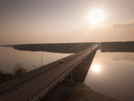 modern buildings bridge with empty road under sunset sky.の写真素材