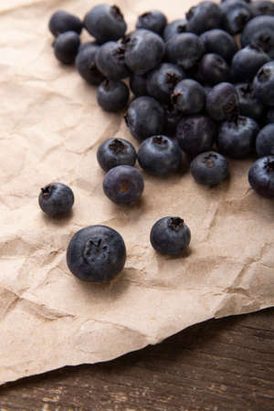 Heap ripe sweet blueberries on rustic paper top viewの写真素材