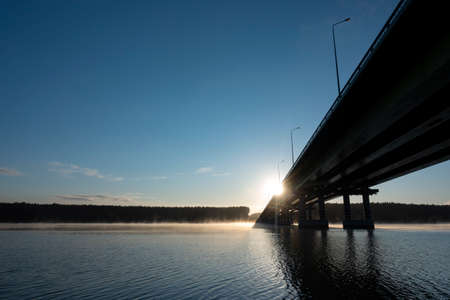 Beautiful sunset road Highway with river Bridge