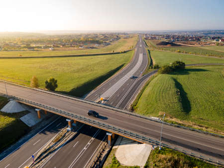 Highway intersection junction summer morning with car. Drone Aerial Top Viewの写真素材