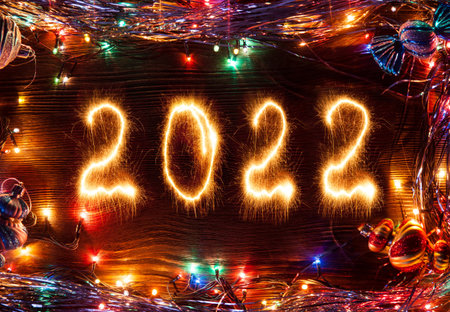 Happy New Year 2022 with lights and decoration on wood backgroundの写真素材