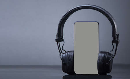 headphones with smartphone mockup, isolate on gray, music online concept.の写真素材