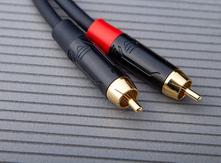 Hi-Fi RCA gold audio cable on gray background