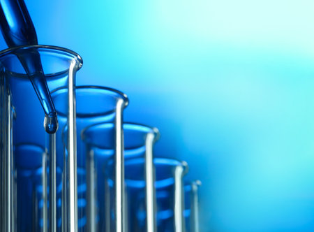 glass test tube with dropper on blue background with substance.の写真素材