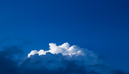 Clouds on a blue sky with Sun light rays or beams bursting. Spiritual religious concept background.