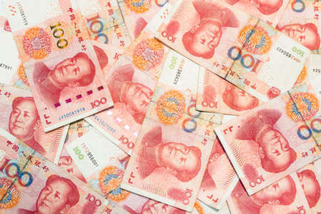 Many of one hundred Chinese yuan banknotes, Chinese currency as background.の写真素材