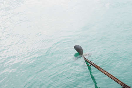 Close up of long tail boat propeller in water.の写真素材