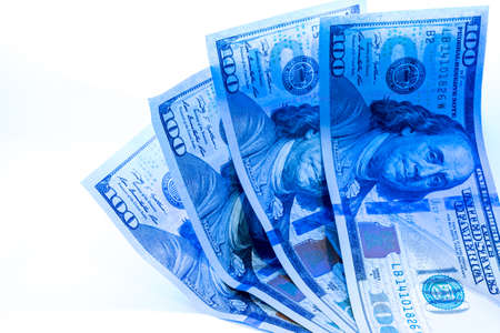 Counterfeit dollar currency detection, Checking one hundred dollar banknotes with ultraviolet light or black light.の写真素材