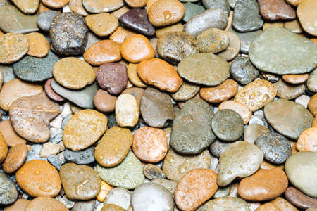 Wet brown pebbles stone texture on the ground in bathroom. Abstract nature background.の写真素材