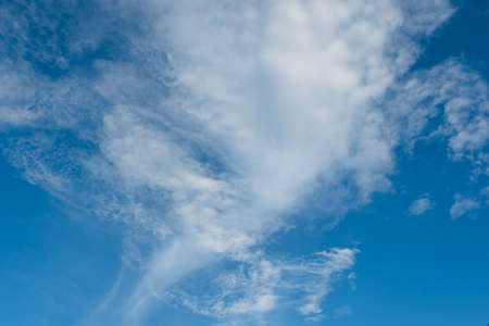 Blue sky with fluffy white clouds.