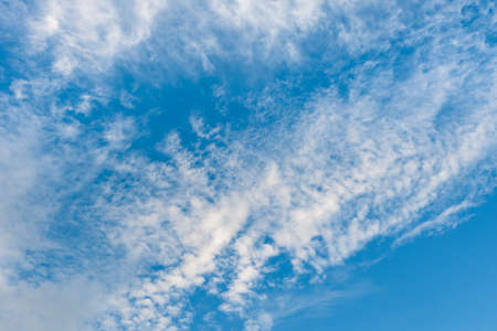 Blue sky with fluffy white clouds.の写真素材