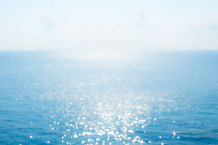 Abstract sunlight bokeh on blue sea background for summer season.の写真素材