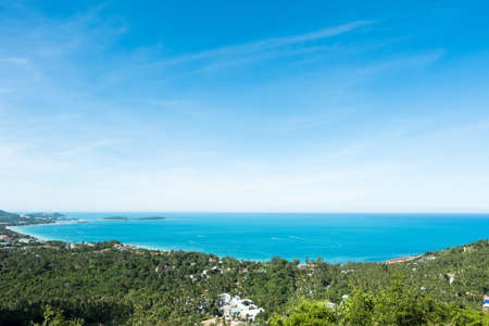 Sea view at Chaweng beach in Koh Samui, Thailand. The scenery of seascape and bay with city and forest of coconut trees in aerial view on summer day.の写真素材